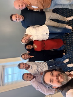 A group of people smiling for a photo indoors