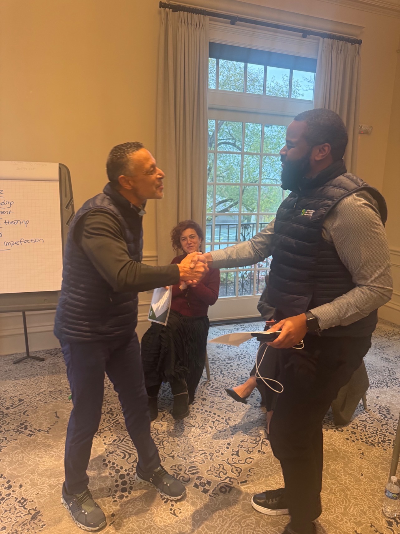 Two men shaking hands indoors