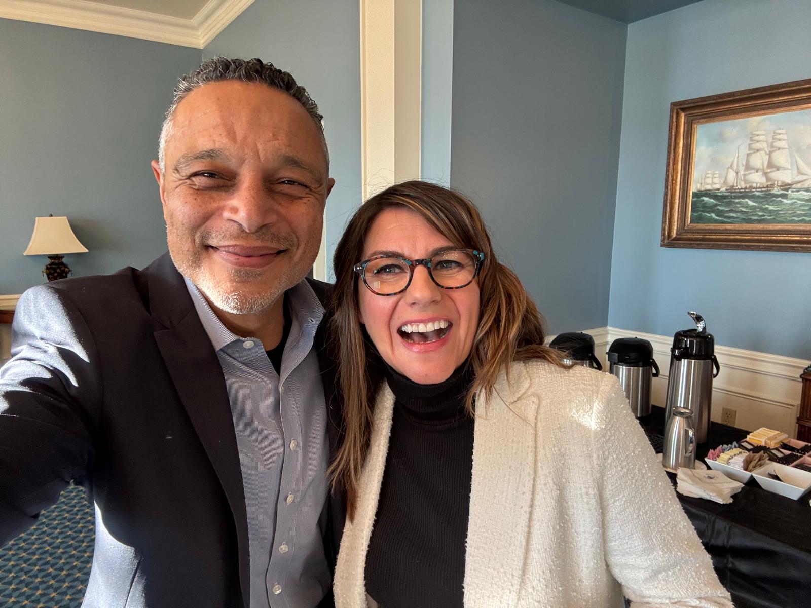 A man and a woman smiling indoors